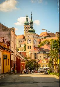 a city with a clock tower on top of a building at Nicolsburg in Mikulov