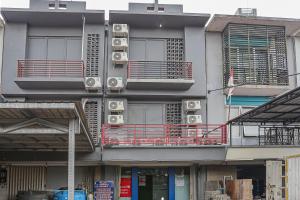 a building with air conditioners on the side of it at OYO 93772 Iconiq Rooms in Bekasi