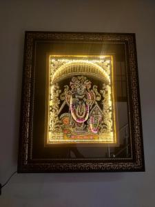 a picture of a statue in a gold frame at Shri Achyutam Villas in Vrindāvan