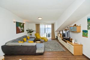 a living room with a couch and a tv at Apartmani Zora in Hvar