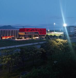 a large red building in front of a building at Obilex in Podgorica