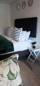 a bedroom with a bed with pillows and a table at ocean dune sibaya in La Mercy