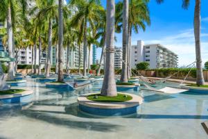 a row of palm trees in a swimming pool at 1435 Brickell Ave 3004 in Miami