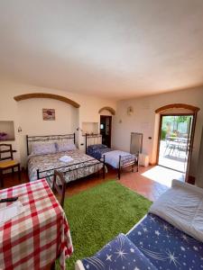 Habitación con 3 camas y alfombra verde. en La Valle di Anna, en Lastra a Signa