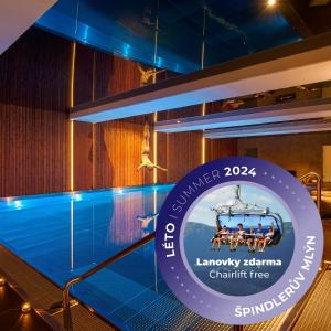 a pool on the deck of a cruise ship at night at Hotel Bedriska Wellness Resort & Spa in Špindlerův Mlýn