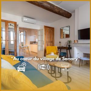 a living room with a yellow couch and a table at Escapade à Sanary au Cœur du Village in Sanary-sur-Mer