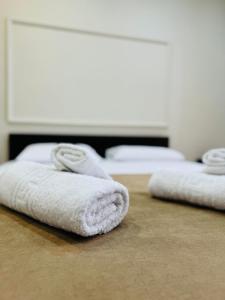 two white towels sitting on top of a table at Elite Haven in Alexandroupoli