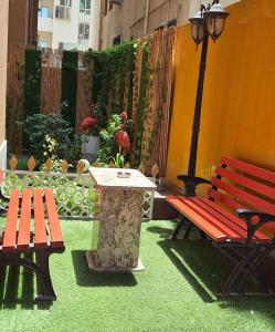 a bench and a table and a table and a street light at Arabian Hotel Apartments in Ajman 