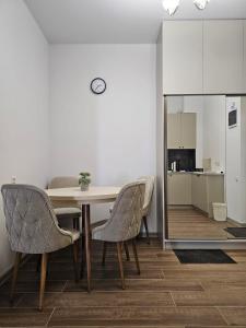 a dining room with a table and chairs and a kitchen at Stay Inn Center in Tbilisi City