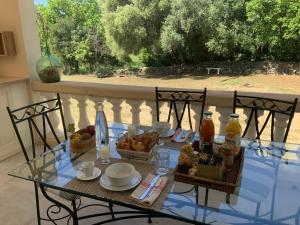 a glass table with food on top of a balcony at U FARNIENTE in Patrimonio