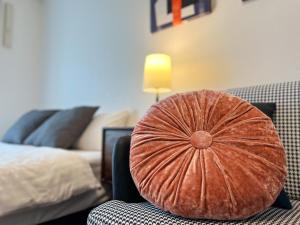 a pillow sitting on a chair in a bedroom at OUCHI HOTEL Hatchobori in Hiroshima