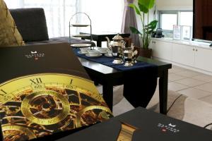 a room with a table with a clock on it at Liberty Walk Red Dragon Okinawa #Welcome! 欢迎! ยินดีต้อนรับ #Presidential Suite Villa #Great access to all locations #Easy money exchange #レッドドラゴン沖縄 #ヨット クルーザー SuperCarオーナー 超富裕層御用達 #世界遺産 #各所アクセス最高 in Minatogawa