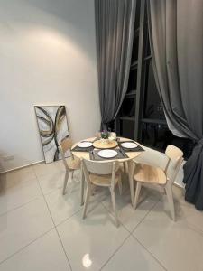 a dining table and chairs in a room with a table and chairsktop at 2 Guest Duplex City Center Eko Cheras Mall Kuala Lumpur Pavilion Bukit Bintang KLCC Petaling Street Central Market National Zoo Batu Caves Merdeka Square in Kuala Lumpur