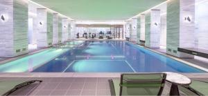 a large swimming pool in a building at L+Snow Supreme Hotel in Shanghai
