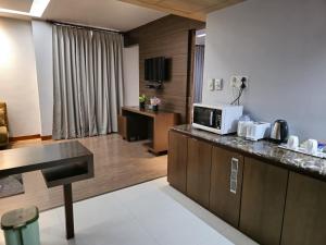 a kitchen with a counter top and a microwave at Hotel Daaysco Oley Allo in Guwahati