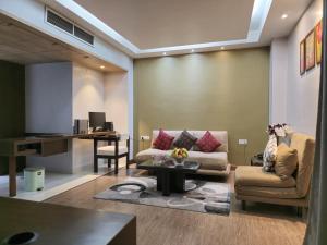 a living room with a couch and a table at Hotel Daaysco Oley Allo in Guwahati