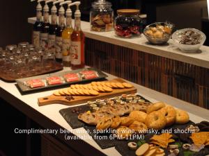 a buffet with different types of food on a table at Mitsui Garden Hotel Osaka Premier in Osaka