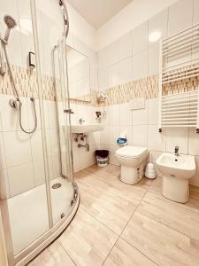 a bathroom with a shower and a toilet and a sink at Dream Hub in Mestre