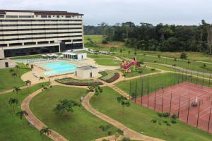 een luchtzicht op een gebouw en een park met een zwembad bij Grand Hotel Djibloho in Djibloho