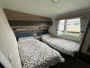 a bedroom with two beds in a room at Lovely 2-Bed Caravan in Prestonpans in Longniddry