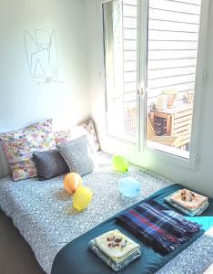 a living room with a couch with balloons and a window at La Fremille - Nid nature - Piscine & terrasse - 400m gare Paris in Saint-Cyr-lʼÉcole