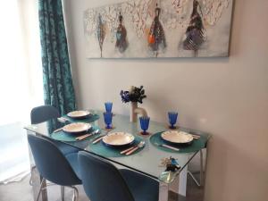 stół jadalny z niebieskimi krzesłami i niebieskim stołem w obiekcie Central 2BR Apartment with Balcony by Apricus Design w mieście Msida