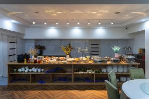 a kitchen with a buffet of food on a table at Regardal Hotel in Almaty