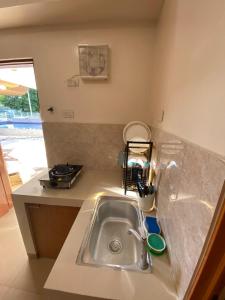 a kitchen with a sink and a counter top at Villa Pamana Inn Puerto Galera powered by Cocotel in Puerto Galera