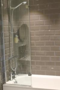 a shower with a glass door in a bathroom at The Swan at Forest Row in Forest Row