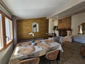 a dining room with a table with a vase of flowers on it at Bel appartement cœur de ville avec terrasses in Cahors