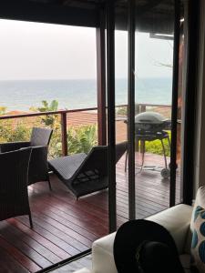 a living room with a balcony with a view of the ocean at Blythedale Splendour in KwaDukuza +20 photos