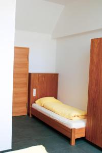 a bedroom with a bed and wooden cabinets at Robbesscheier in Munshausen