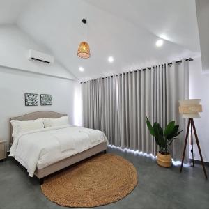 a bedroom with a bed and a large window at Private Villa in Phumĭ Prêk Chrey