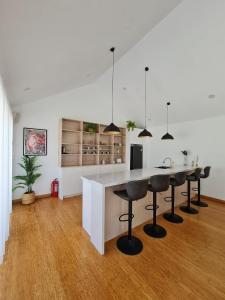 a kitchen with a island with bar stools at Private Villa in Phumĭ Prêk Chrey