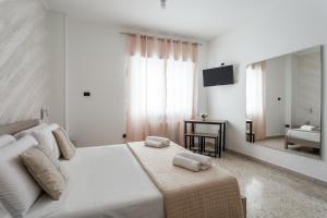 a white bedroom with a bed and a mirror at Napoli Fly Guest House 290 in Naples
