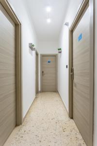 an empty corridor with doors in a building at Napoli Fly Guest House 290 in Naples