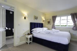a bedroom with a large bed and a window at Crows Hall in Colchester