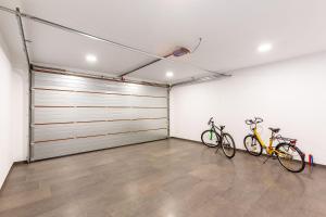 a garage with two bikes parked in it at Villa Luna & Pia for families in Pula for 10 people with heated pool - pet friendly in Pula