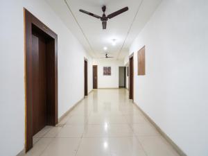 a corridor with white walls and a ceiling at OYO Tathastu Inn in Raipur