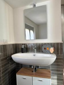 a bathroom with a white sink and a mirror at Le Casette dei Nonni in Alviano +28 photos