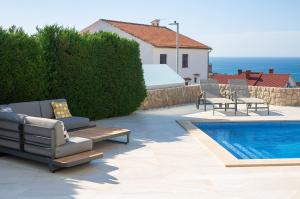 a patio with chairs and a swimming pool at Villa Sia in Krk