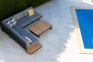 a couch and a table next to a swimming pool at Villa Sia in Krk