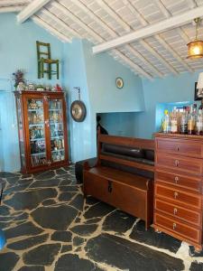 a living room with a wooden dresser and a room with a dresser at Rosa Mar in Cabeça de Carneiro