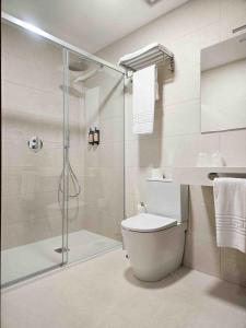 a bathroom with a shower and a toilet and a sink at A Quinta de Cea in Cea