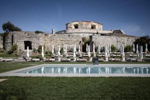 a building with a swimming pool in front of it at Relais Forte Benedek Wine & SPA - Adults Only in Pastrengo