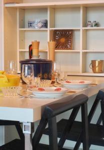 a dining room table with glasses and plates on it at Apartment mit Meeresblick Wangerooge in Wangerooge
