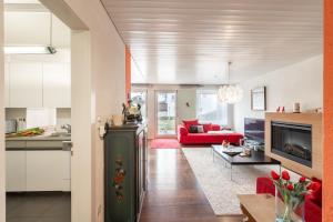 a kitchen and living room with a red couch at Feriensiedlung Trü 2 in Scuol