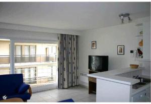 uma sala de estar com uma cozinha com uma grande janela em Residente TOPAZE DE PANNE GEM 1 SLPK APP LUXE AFW & Ruime parking incl em De Panne