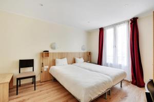 a bedroom with a large bed and a chair at Altona in Paris