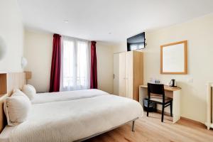 a hotel room with two beds and a desk at Altona in Paris
